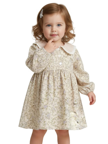 Young girl wearing a vintage floral dress with a white doll collar on a white background